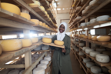 Image showing African black muslim business woman in local cheese production company