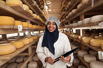 Image showing African black muslim business woman in local cheese production company