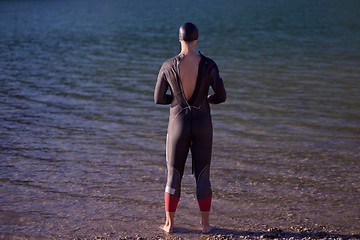 Image showing triathlete swimmer portrait wearing wetsuit on training