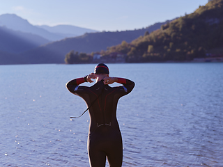 Image showing triathlete swimmer portrait wearing wetsuit on training