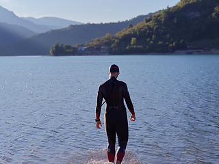 Image showing triathlete swimmer portrait wearing wetsuit on training