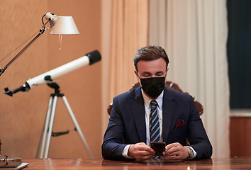 Image showing business man wearing protective face mask at office