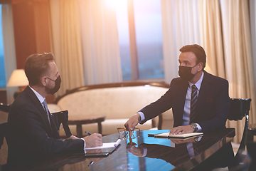 Image showing business people wearing crona virus protection face mask on meeting