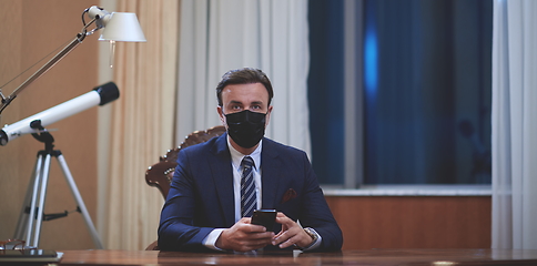 Image showing business man wearing protective face mask at office