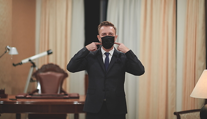 Image showing business man wearing protective face mask at office