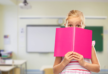 Image showing little girl hiding over book