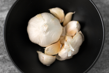 Image showing garlic in bowl on slate stone background