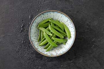 Image showing peas in bowl on wet slate stone background