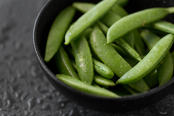 Image showing peas in bowl on wet slate stone background