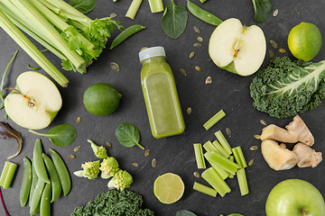 Image showing close up of bottle with green juice and vegetables