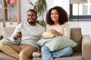 Image showing african couple with popcorn watching tv at home