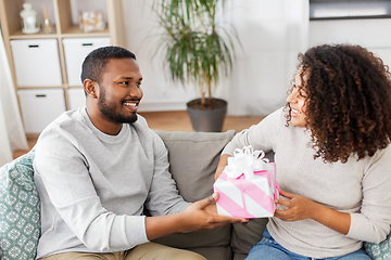 Image showing happy couple with gift at home