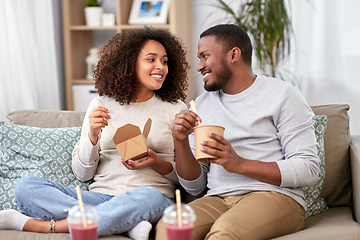 Image showing happy couple with takeaway food and drinks at home