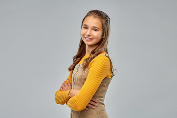 Image showing smiling young teenage girl with crossed arms