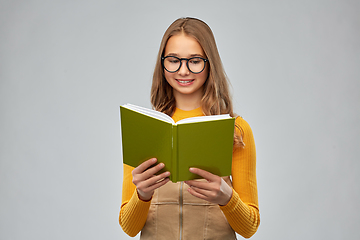 Image showing teenage student girl in glasses reading book