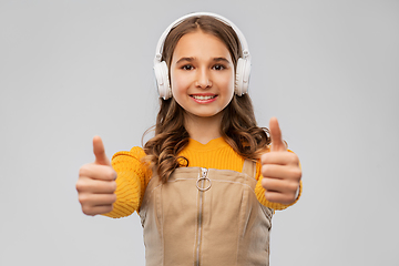 Image showing teenage girl in headphones showing thumbs up