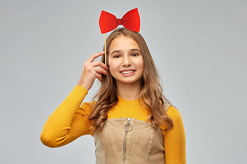 Image showing happy teenage girl with red bowtie party accessory