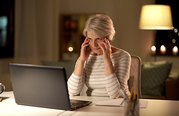 Image showing tired senior woman with laptop at home at night