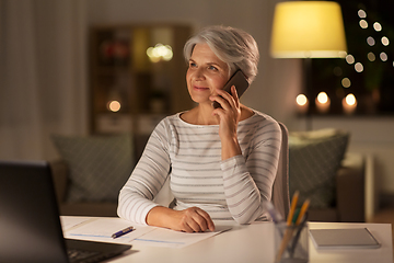 Image showing old woman calling on smartphone at home at night