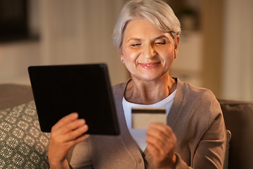 Image showing old woman with tablet pc and credit card at home