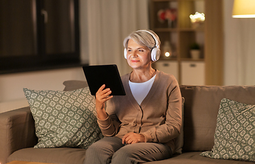 Image showing senior woman in headphones listening to music