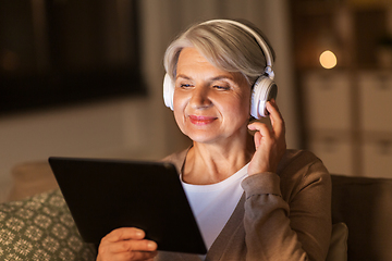 Image showing senior woman in headphones listening to music