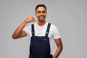 Image showing happy worker or builder making phone call gesture