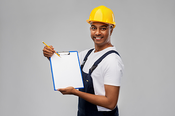 Image showing happy builder in helmet with clipboard and pencil