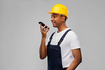 Image showing happy indian builder recording voice on smartphone