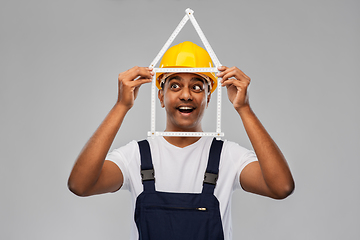 Image showing happy indian builder with ruler in shape of home