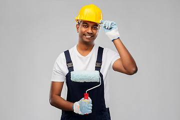 Image showing happy indian painter or builder with paint roller