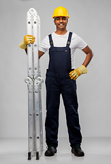 Image showing happy indian builder in helmet with ladder