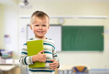 Image showing portrait of smiling boy holding book at school