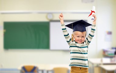 Image showing little boy in mortar board with diploma at school