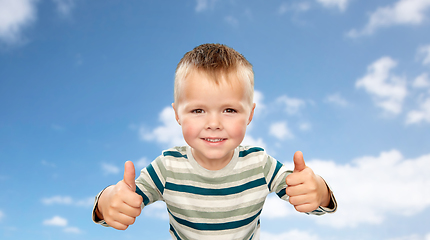 Image showing smiling boy in striped shirt showing thumbs up