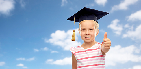 Image showing little girl in mortarboard showing thumbs up