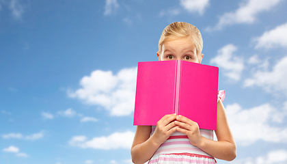 Image showing little girl hiding over book