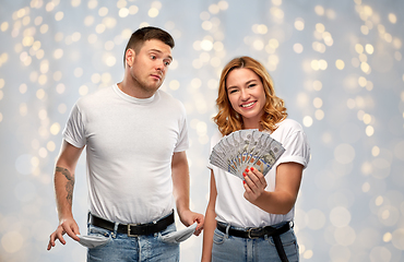 Image showing woman holding money and sad man with empty pockets