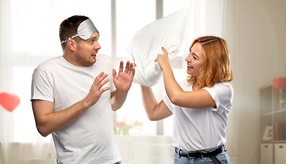 Image showing couple with eye sleeping mask having pillow fight