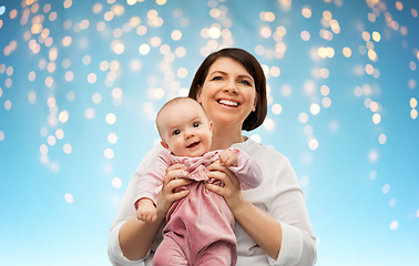 Image showing happy middle-aged mother with little baby daughter