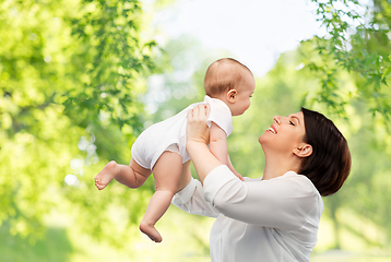 Image showing happy middle-aged mother with little baby daughter