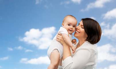 Image showing happy middle-aged mother with little baby daughter