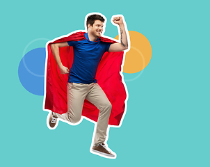 Image showing man in red superhero cape jumping in air