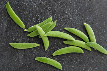 Image showing peas on wet slate stone background