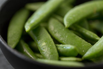 Image showing peas in bowl on wet slate stone background