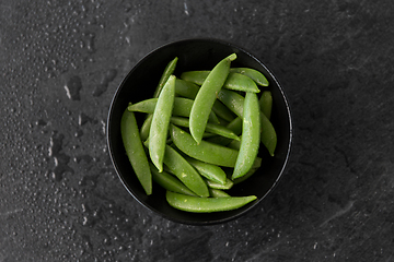 Image showing peas in bowl on wet slate stone background