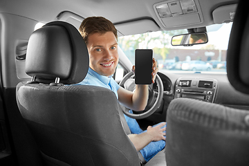 Image showing man or car driver showing smartphone