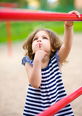 Image showing Cute little girl is playing in playground