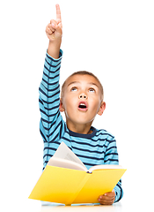 Image showing Little boy is reading a book