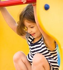 Image showing Cute little girl is playing in playground